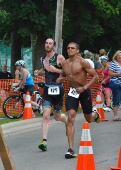 Dustyn Schrock, left, and David Hernandez sprint to the finish of the 2014 Warsaw Optimist Triathlon. (File photo by Nick Goralczyk)