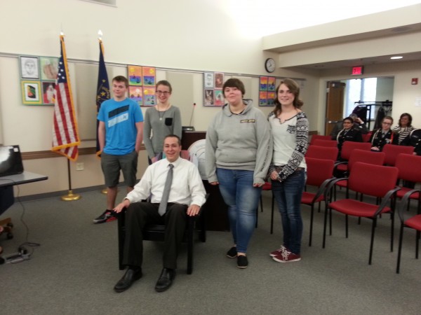 Students pose with Dr. David Hoffert as he relaxes in his new chair.