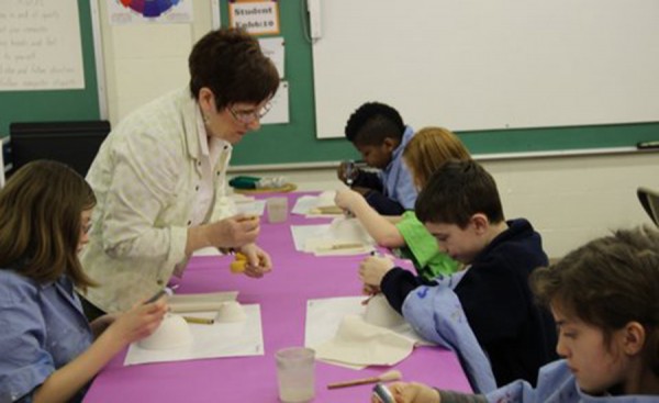 Sixth graders at Warsaw Christian paint bowls for the upcoming Empty Bowls event.