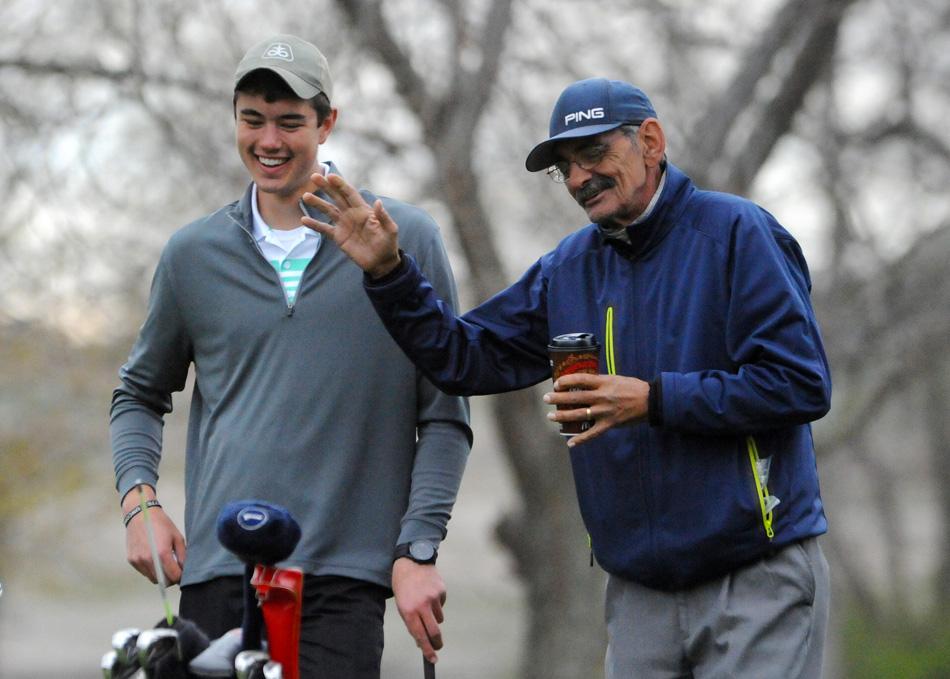 Wawasee golfer Mason Germonprez and Fairfield head coach Randy Schrock joke around before the fifth tee.