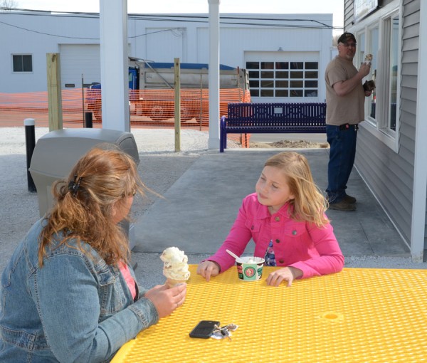 Bobbi and Brianna Feldman sit at one of the outside tables enjoying their ice cream, while talking with Kyle Miller who just received his specialty. 