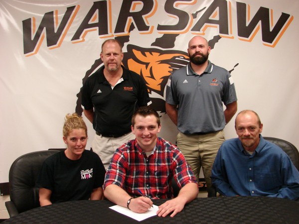 WCHS senior Caleb Wooldridge is headed to play football at Anderson University. Wooldridge is shown above with his parents Vickie and Christopher. In back are WCHS football coach Phil Jensen and WCHS defensive coordinator Kris Hueber (Photo provided)