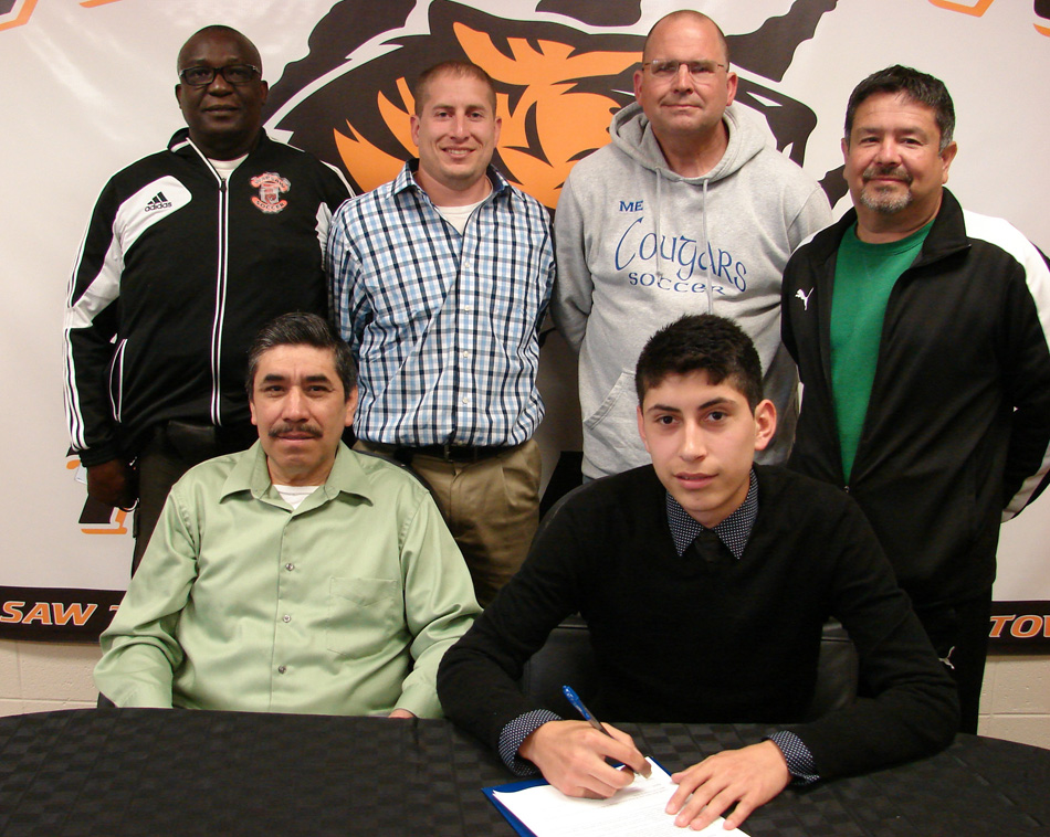 Warsaw Community High School soccer star Tito Cuellar has chosen to continue his soccer career at St. Francis. Seated with Tito is father Jose Cuellar. In the back row are WCHS head coach Frank Courtois, WCHS assistant coach James Hornady, Saint Francis head coach Mitch Ellison and Saint Francis assistant coach Francisco “Paco” Castillo. (Photo provided by Warsaw Athletics)  