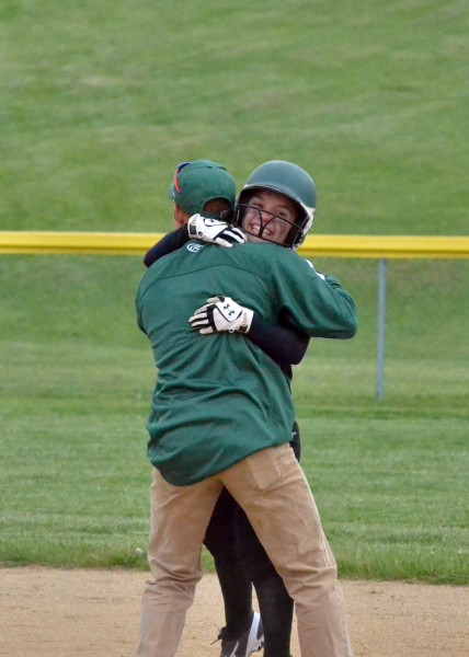 Ale Brito is given a big bear hug by Wawasee assistant coach Jace Stewart after she gave the Lady Warriors a 4-2 lead in the bottom of the sixth inning. (Photos by Nick Goralczyk)