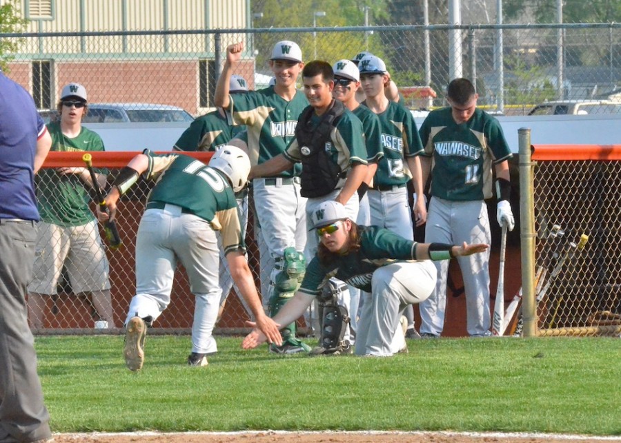 Caleb Dingeldein (15) makes his way to the dugout after giving  his team a 3-0 lead in Wednesday's 14-1 win at Warsaw. (Photos by Nick Goralczyk)