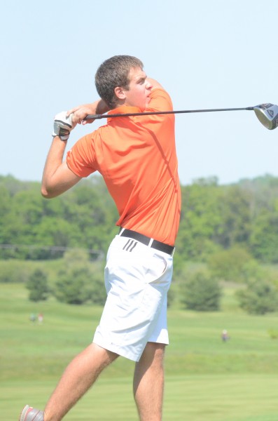 Warsaw senior Brandon Eckert watches his  drive Saturday during the NLC Tourney in Middlebury. Eckert led the champion Tigers with a 77.