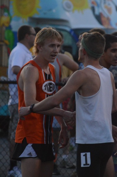 Daniel Messenger of Warsaw is congratulated by a fellow competitor after winning the 800 at the regional Thursday night.