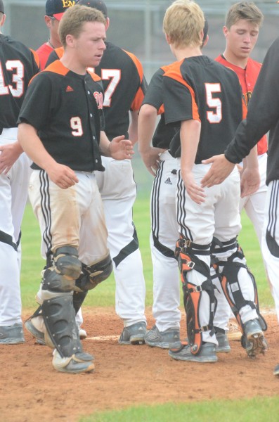 Warsaw catcher Ryan Marshall congratulates his teammates after a 10-6 sectional win over Memorial on Saturday.