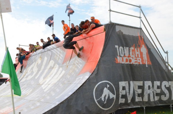Blackwell clings on as teammates work to pull her up the Everest obstacle.
