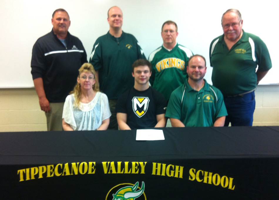 TVHS senior Devin Childers has signed on to wrestle at Manchester University. Seated with Devin are parents Chanelle and Don Childers. In the back row are THVS athletic director Duane Burkhart, Principal Michael Bendicsen, TVHS wrestling coach Scott Smith, and TVHS assistant wrestling coach Sam Davis. (Photo provided by TVHS Athletics)