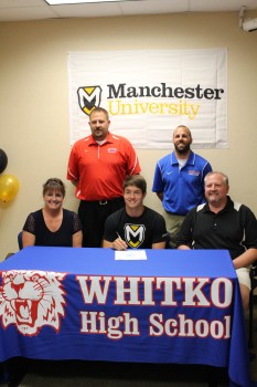 Whitko High School senior Cole Kessie will play football at Manchester University. Kessie is shown above with his parents Tina and Doug. In back are Whitko football coach Josh Mohr and Whitko athletic director Casey Stouffer (Photo provided)
