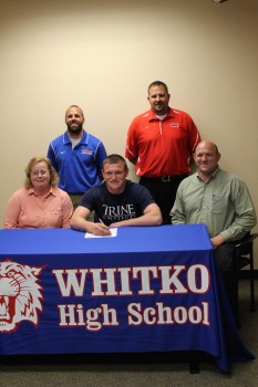 Whitko High School senior Zach Baughman will continue his football career at Trine University. Baughman is shown above with his parents Elaine and Jim. In back are Whitko athletic director Casey Stouffer and Whitko football coach Josh Mohr (Photo provided)
