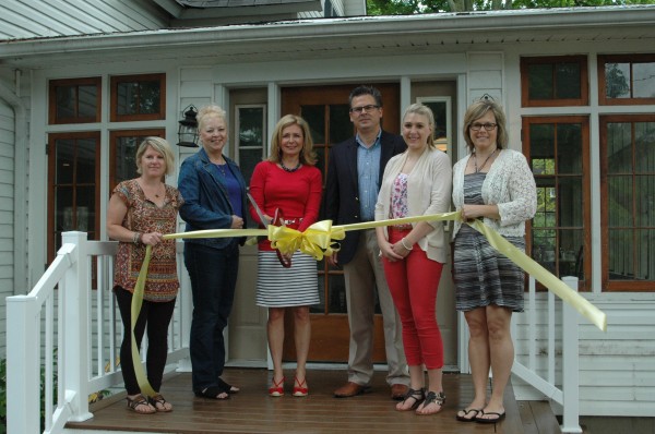 Present at the ribbon cutting ceremony were, from left, Wawasee-Syracuse Chamber of Commerce members Kristy Rumfelt, Sylvia Gargett, Reecer Properties President Lynn Reecer, Vice President James Reecer, Lakes Transaction Coordinator Kate Leach, Executive Director of Syracuse-Wawasee Chamber of Commerce Tammy Cotton. (Photo by David Hazledine)