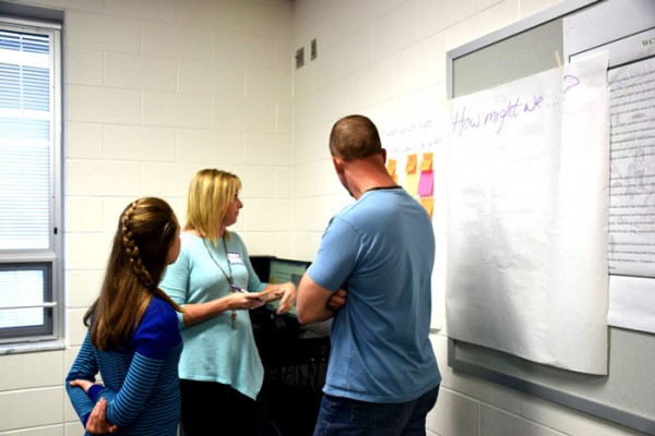 Bronwyn Bonner, left, works with Wawasee High School teacher Traci Henn, middle, and father Pete Bonner, right, to discuss ideas added to their chart. 