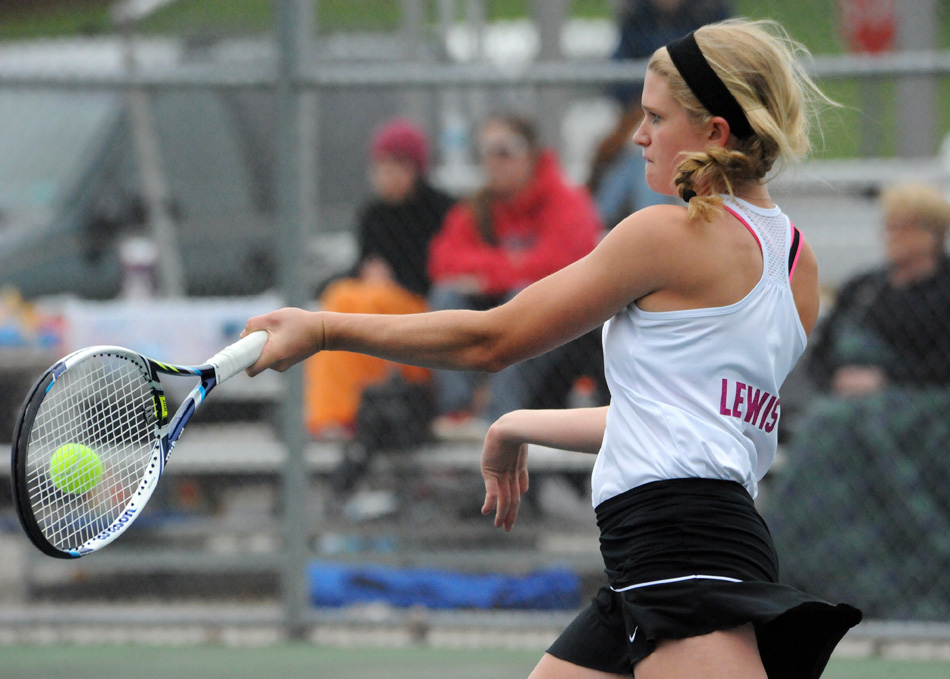 Warsaw No. 1 singles player Liza Lewis crushes a winner against Columbia City's Maddy Minnick Wednesday in the opening round of the Warsaw Girls Tennis Sectional. (Photos by Mike Deak)