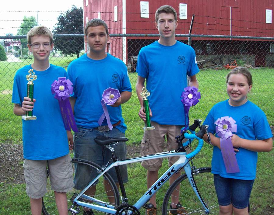 The photo shows the division winners , from left, are: Isaac Inniger, New Paris, junior division champion; Alec Calkins, Elkhart, senior division reserve champion; Sr. Division Champion – Lucas Inniger, New Paris, senior division champion; and Paige Jacobs, Nappanee, junior division reserve champion.