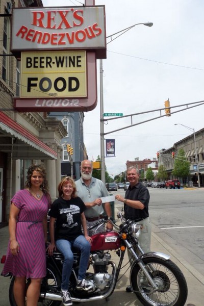 (From left) Front of bike- Amy Kellar, medical social worker; Arica Hoffer, event organizer at Rex’s. Back: Robin Watters, Rex’s owner; and Rick Paczkowski, Kosciusko Home Care & Hospice administrator.  (Photo provided) 
