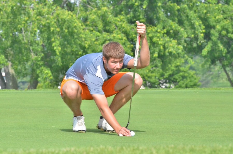 Warsaw's Ryan Cultice places his ball before making a putt on the ninth green at Rozella Ford Golf Club. (File photos by Nick Goralczyk)