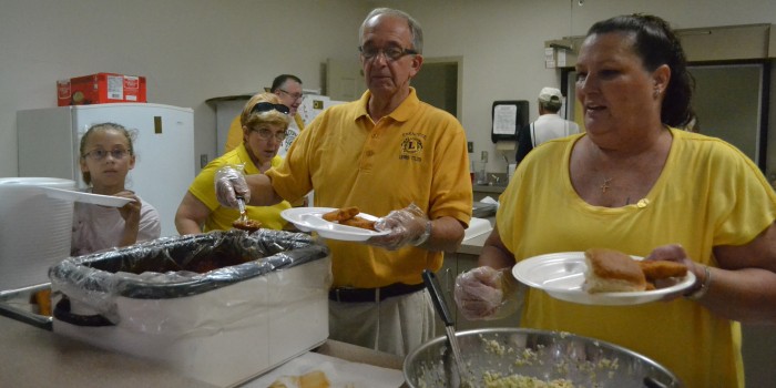 From left, Jennifer Brace, Tom Thornburg and Sandra Mignery make up the serving line at the Syracuse Lions Club's annual Jonah Fish Fry. (Photo by Sarah Wright)