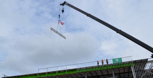 A crane hoists the final beam in the construction of the new Parkview Warsaw facility during Wednesday's topping-out ceremony. (Photo by Amanda McFarland)
