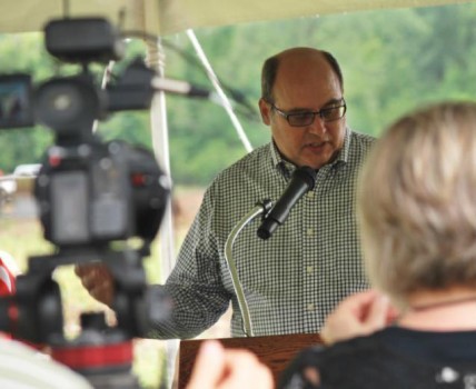 Co-founder and president of Poly-Wood, Inc., Doug Rassi, speaks at the ground breaking ceremony Thursday, June 25.