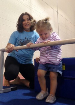 Nika Prather (left) helps Caraline Deak through the romp and roll course at the North Webster Community Center.