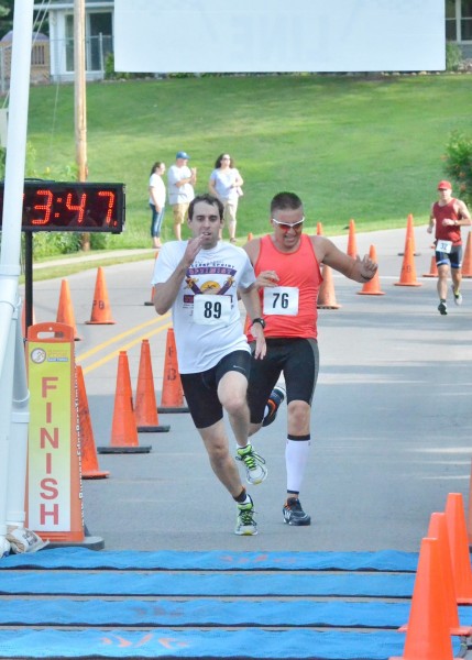 Cole Patuzzi (left) narrowly slips by Cole Richards at the finish line of the 8th annual Wawasee Kiwanis Triathlon/Duathlon. (Photo by Nick Goralczyk)