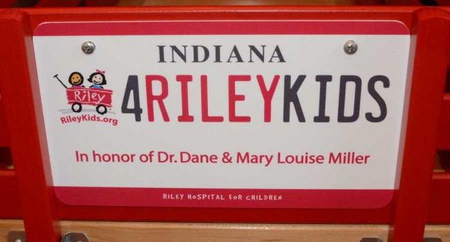 License plate to be placed on a red wagon honoring Dr. Dane and Mary Louise Miller