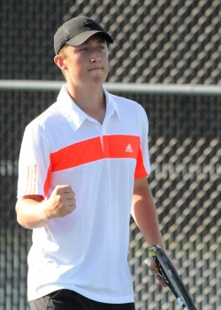 Warsaw's Colton Lind gestures after scoring a point in the one doubles matchup against Penn.