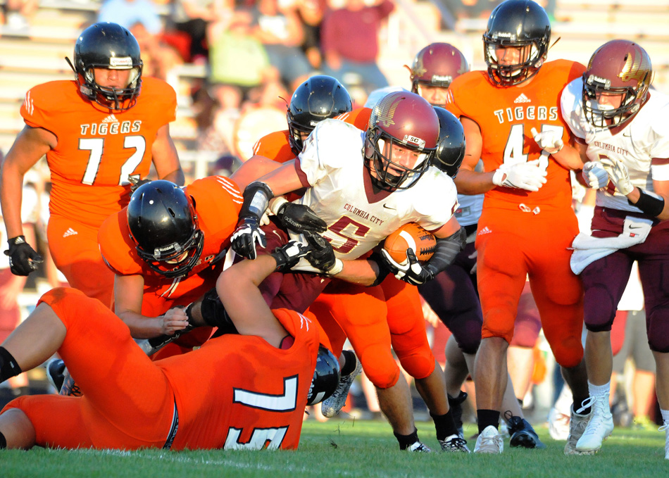 Keegan Bays (75) and a host of Tiger defenders swarm Columbia City running back Carson Reed. The Eagles averaged just two yards per carry against the Tigers.