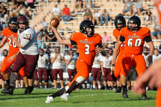 Warsaw quarterback Michael Jensen finds room to scramble against Columbia City. (Photos by Mike Deak)