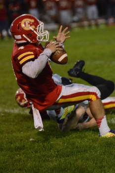 Memorial quarterback Zach Hawkins looks for a receiver while being tackled.