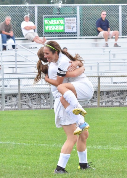 Sarah Lancaster leaps into Leigh-Ann Shrack's arms after feeding the junior for Wawasee's first goal in Wednesday's 2-0 win over Whitko. (Photos by Nick Goralczyk)