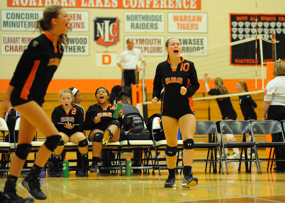 Warsaw's Grace Johnson (10) celebrates with her team after a point scored against St. Joe.