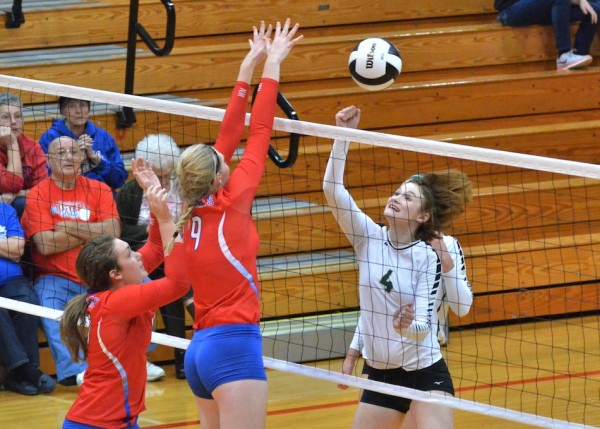 Kaylie Warble (9) blocks a ball from Becca Anderson.