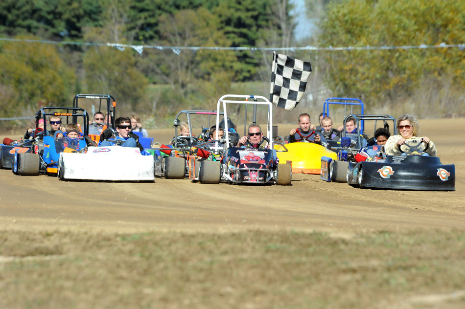 Randy Brandon, in the 57 car, is surrounded by drivers as they take a memorial lap around Akron Speedway Sunday in honor of Tony Elliott. (Photos by Mike Deak)