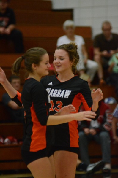 Warsaw's Caroline Mayer (right) celebrates with Cassie Hoag during a win at NorthWood Thursday night.