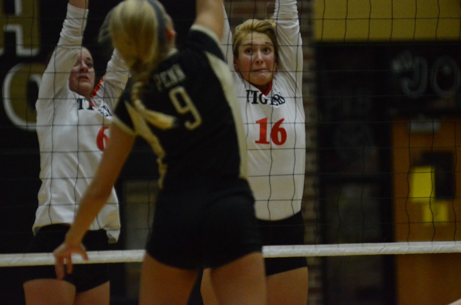 Jordyn Lindeman (at right) goes up for a block for Warsaw Monday night at Penn. The senior standout led the Tigers to a 3-0 victory.