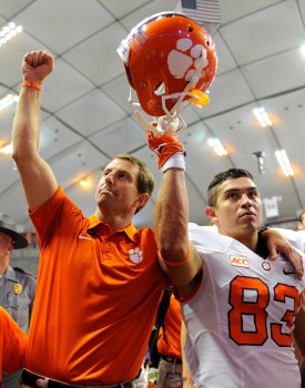 Oct 5, 2013; Syracuse, NY, USA; Clemson Tigers head coach Dabo Swinney (left) and wide receiver Daniel Rodriguez (83) gesture to the crowd following the game at the Carrier Dome. Clemson defeated Syracuse 49-14. Mandatory Credit: Rich Barnes-USA TODAY Sports
