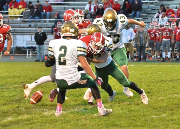 Nick LeCount (27) forces a fumble for Wawasee on Goshen's opening drive. 