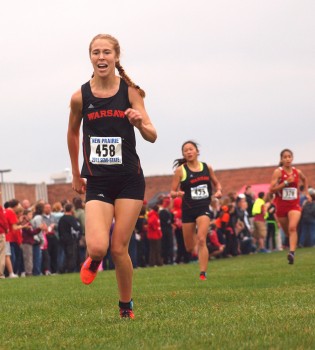 Warsaw's Allison Miller and Anna Craig motor around the New Prairie Cross Country Semi-state course Saturday, helping the Tigers to a state appearance. (Photos by Tim Creason)