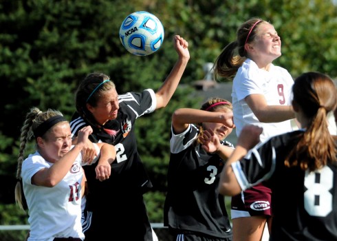 Warsaw's Anna Grill tries to get a head to the ball on a cross between Culver defenders.