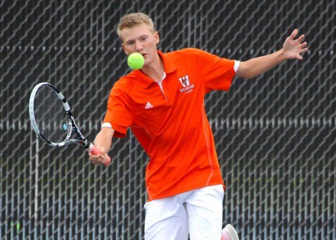 David Homme of the Warsaw No. 1 doubles team, efforts a shot against Wawasee.