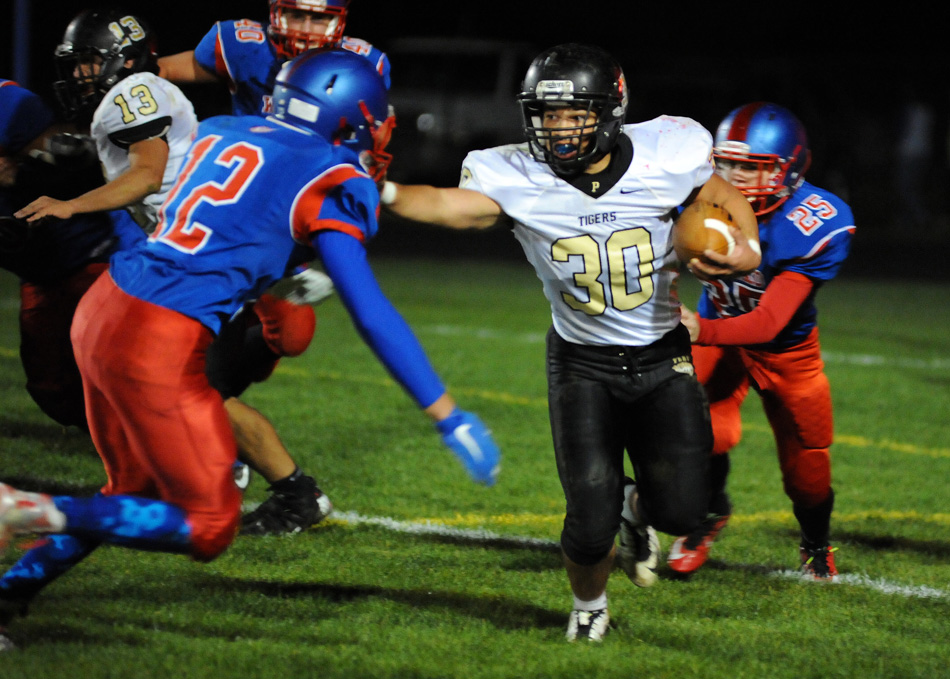 Peru running back Jordan Rader eludes Whitko's Brady Weeks Friday night in the TRC championship game. Rader had two touchdowns to help the Tigers to a 19-7 win over the Wildcats. (Photos by Mike Deak)