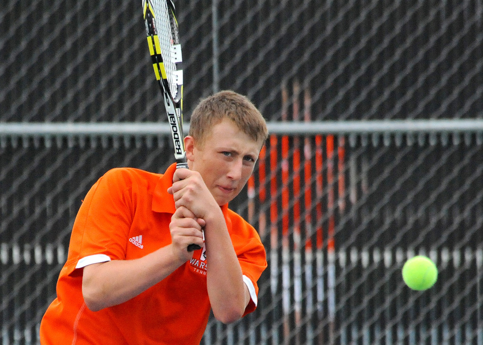 Warsaw No. 2 Colton Lind follows through on a return against Cal Heinisch in the Warsaw Boys Tennis Sectional finals. (Photos by Mike Deak)