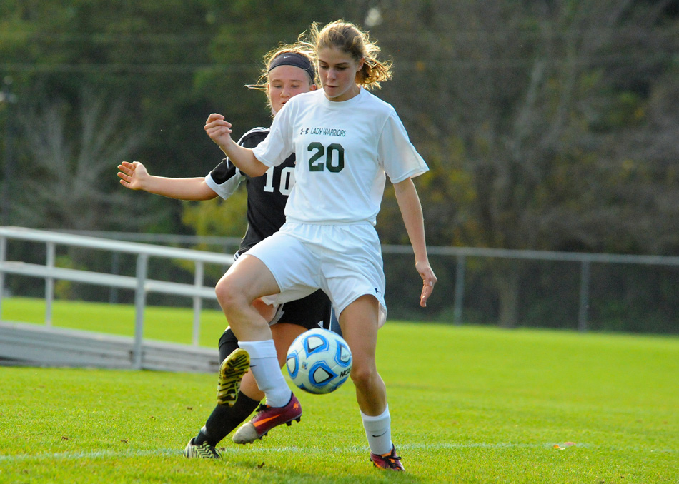 Warsaw senior forward Elizabeth Van Wormer wraps around Wawasee defender Bethany Hapner to get the touch on what would become goal number 68 in her illustrious career, passing Meredith Hollar as the all-time goal scorer in Warsaw girls soccer history. (Photos by Mike Deak)
