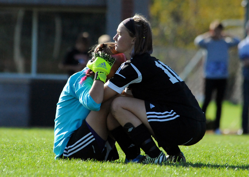 Warsaw senior Liz Van Wormer consoles teammate Chloe Snow after Culver Academy won the penalty kick shoot-out.