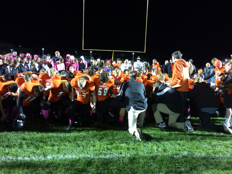 The Warsaw football community took a moment Friday night to pray for the Smith family after hearing of the news of Charlie and Scott Smith's passing. Scott Bibler and Tony Elliott were also killed in the plane crash outside of Clemson, SC, Friday evening. (Photo by Mike Deak)