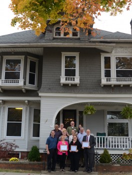 Guests visiting the Serenity House No. 7, stand on the front steps of this 1907 built home, which now houses 16 men wanting to recover from drugs and alcohol addiction.