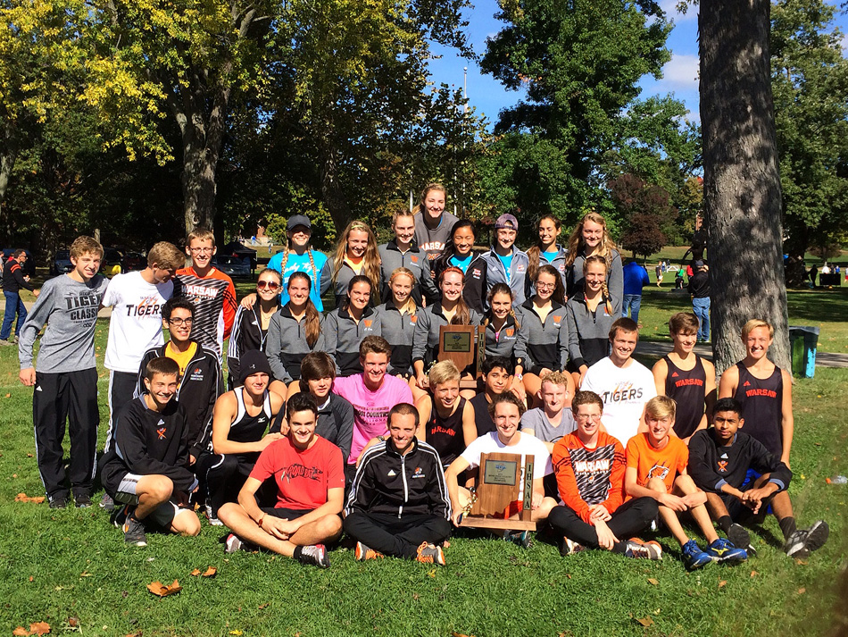 Warsaw's boys and girls cross country teams pose together after winning the team titles Saturday morning at the Culver Academy Cross Country Sectional. (Photos by Mike Deak)